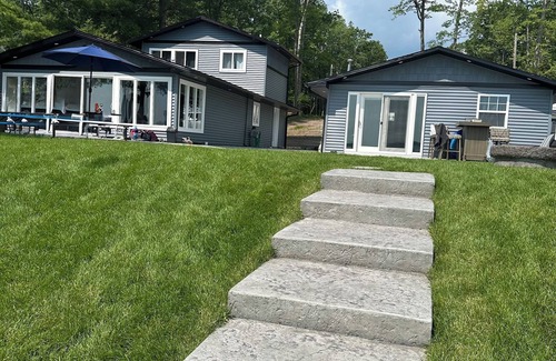 Higgins Lake House | Gather in this modern retreat with boat mooring.