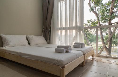 Khanong Phra Apartment | Inviting Golf View Suite with Kitchen and Family Amenities