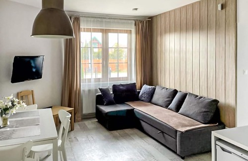 Karwia Apartment | Modern Vacation Apartment with Family-Friendly Garden