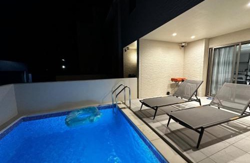 Onna House | Unforgettable Stay at Grandioso Onna 7-D: Poolside Bliss