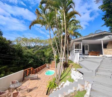Palhoca House | Gray House: Poolside Retreat Steps from the Ocean