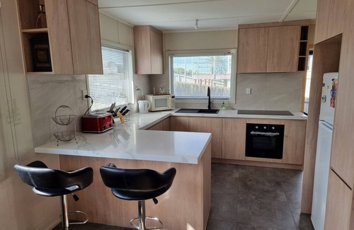 Pukehina House | Discover Great Bach with Oceanfront Views & Family Amenities