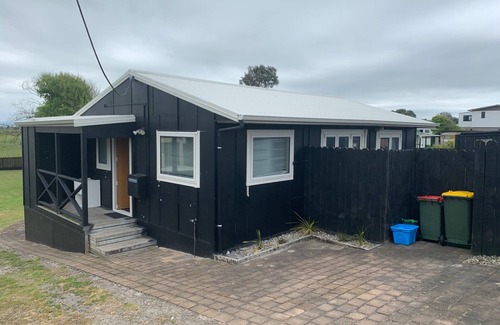 Pukehina House | Discover Great Bach with Oceanfront Views & Family Amenities
