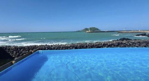 Hallim House | Relax at Hay Day Jeju: Oceanfront Retreat with Pool Access