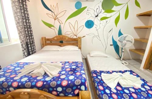 Capurgana Hotel | Discover Hostal Las Flores: Family-Friendly with Breakfast
