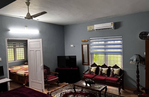 Thiruvananthapuram Hostel | Vibrant Party House Guest Rooms with Cozy Fireplace