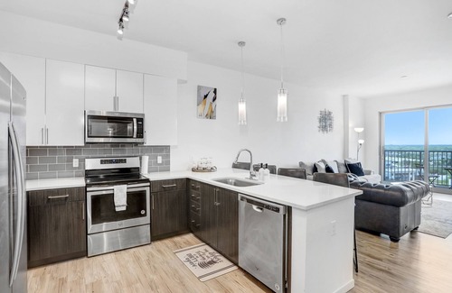 Channel District Apartment | Indulge in a City View Sky Lounge & Top Gym Access