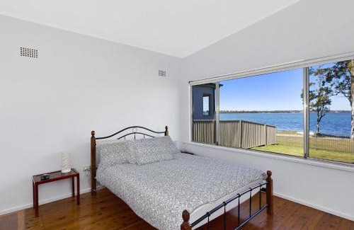 Buff Point House | Pet-Friendly Lake Edge Cottage with Oceanfront Views