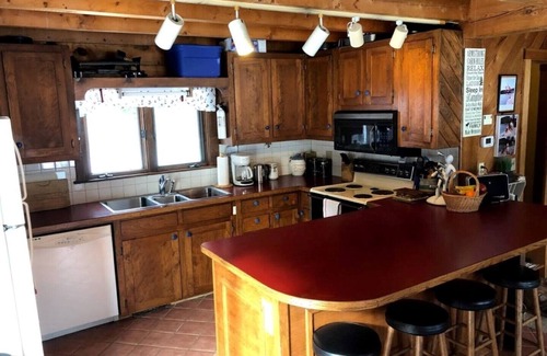 Bryant Pond House | Cozy Log House with Lake Views, Pool, and Kayaking Fun