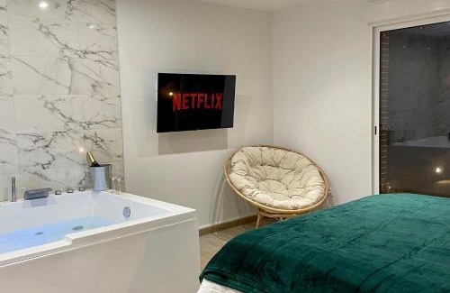 Evreux Apartment | Elegant L’Esmeralda Spa: Relaxing Getaway with Hot Tub
