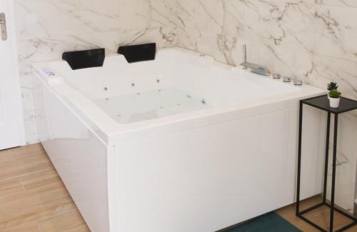 Evreux Apartment | Elegant L’Esmeralda Spa: Relaxing Getaway with Hot Tub