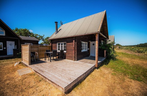 Sønderstrand Cabin | Cozy Log Cabin Retreat with Horse Stables by the Sea