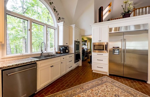 Cumming House | Experience a Private Sandy Beach and Scenic Lake Views