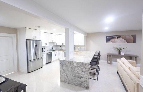 Garden Isles House | Stylish Poolside Retreat Steps from Beach and Golfing