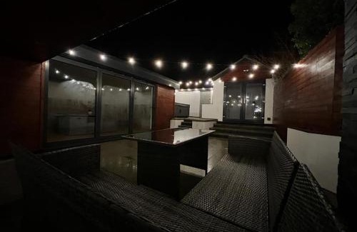 Roughton House | Trendy Upside Down Retreat with Hot Tub & Family-Friendly Perks