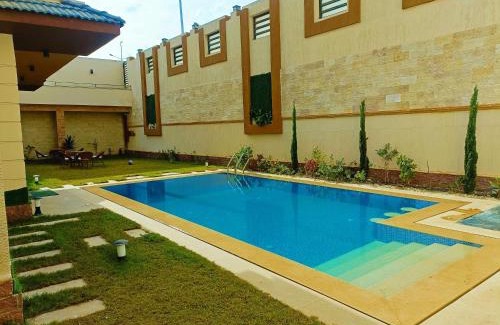 Sheikh Zayed City Apartment | Experience My Villa: 4-Star Stay with Pool & Breakfast