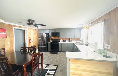Alpena House | NEW LISTING! Spacious 4-bedrooms lake front retreat in delightful Alpena area.