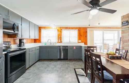 Alpena House | NEW LISTING! Spacious 4-bedrooms lake front retreat in delightful Alpena area.