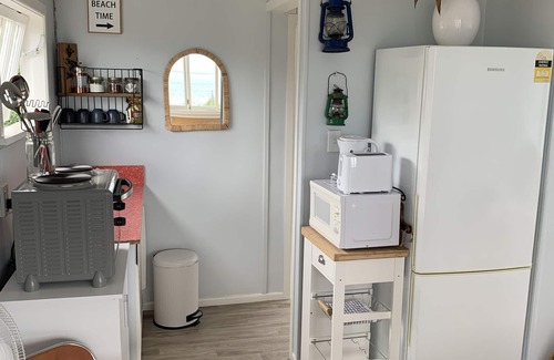 Cape Palliser House | Unwind in Oceanfront Beach Hut with Kaikoura Views