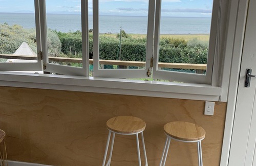 Cape Palliser House | Unwind in Oceanfront Beach Hut with Kaikoura Views
