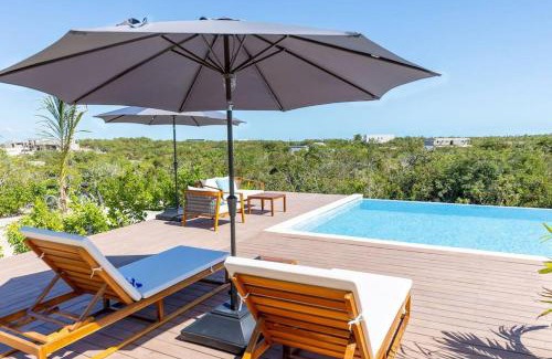 Long Bay Apartment | Discover Onyx I Long Bay Retreat: Poolside Paradise Near Beaches
