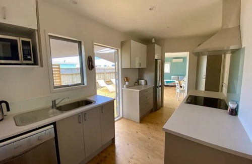 Ohope House | Oystercatcher Bach: Oceanfront Retreat with Pool & Breakfast
