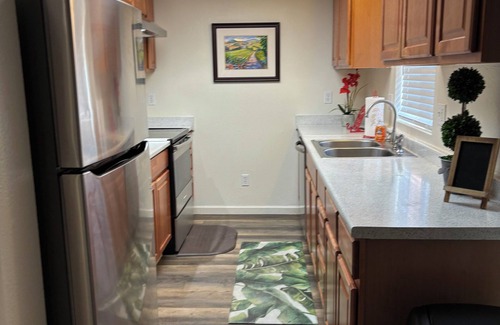 Lemoore House | Discover Palm Oasis: Top-Rated Stay with Pool & Breakfast