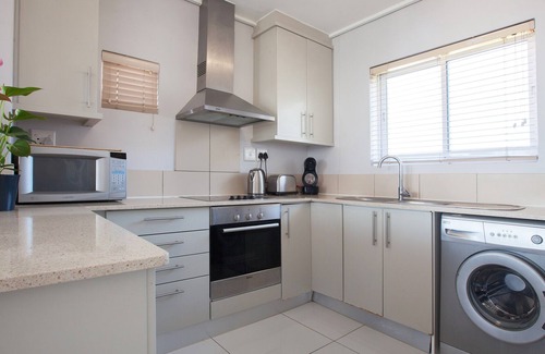 Lagoon Beach Apartment | Beachfront Retreat with Balcony and Pool Access