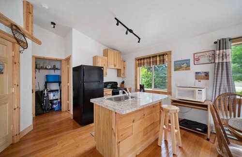 Carp Lake Cabin | Lakefront Log Cabin with Pool & Family-Friendly Amenities