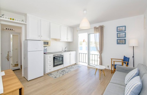 Es Grau Apartment | Ponent-Beachfront Apartment: Relaxing Coastal Retreat Awaits