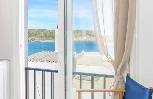 Es Grau Apartment | Ponent-Beachfront Apartment: Relaxing Coastal Retreat Awaits