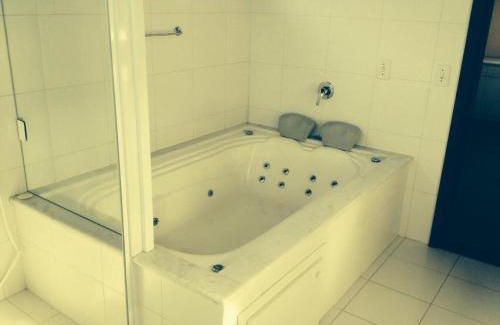 Praia do Rosa Apartment | Master Suite at Pousada Águas de Ibiraquera with Ocean View