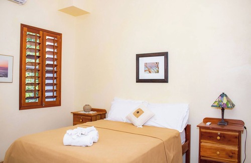 Orchid Bay Bed & Breakfast | Queen-size bed, with a private bathroom, a walk-in shower and closet.