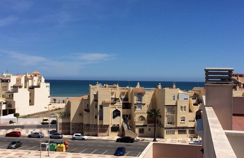 Roquetas de Mar Apartment | Cozy Apartment Steps from Beach with Pools & Ocean Views
