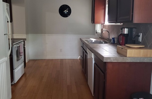 Woodfin House | Unwind Under the Trees with Family-Friendly Amenities