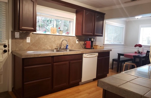 Woodfin House | Unwind Under the Trees with Family-Friendly Amenities