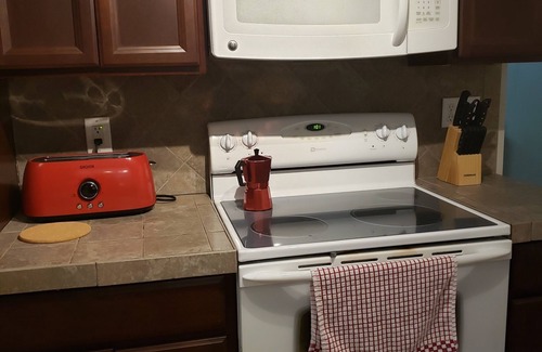 Woodfin House | Unwind Under the Trees with Family-Friendly Amenities