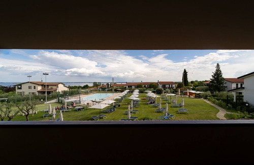 Moniga del Garda Apartment | Discover Residence Primera: Oceanfront Escape with Spa