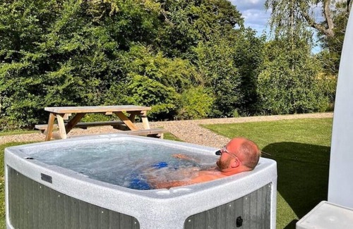 Legbourne Cabin | Enchanting Riverside Retreat with Private Hot Tub