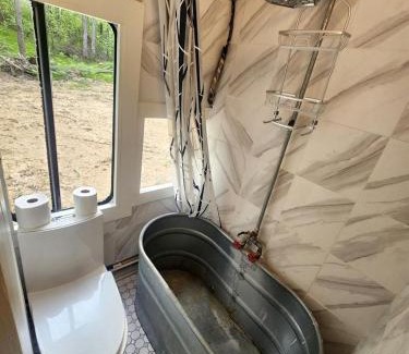 Bitely House | Rustic Converted School Bus with Outdoor Shower Near ORV Trails in Manistee National Forest, Michigan