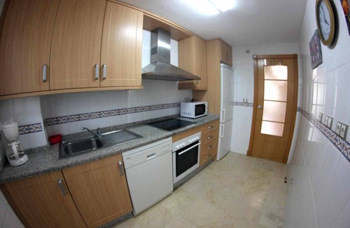 Manilva Apartment | Sabinillas Retreat: Terrace, Shared Pool & Private Parking