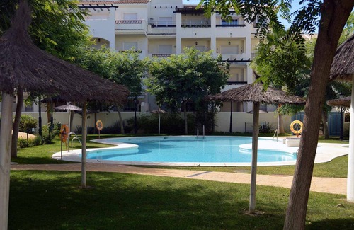 Manilva Apartment | Sabinillas Retreat: Terrace, Shared Pool & Private Parking