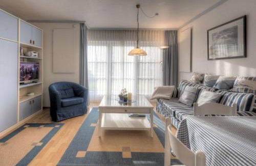 Busumer Deichhausen Apartment | Enchanting Seeschlößchen Nr 6: Oceanfront Family Retreat