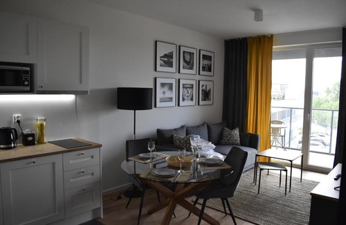 Witomino Apartment | Modern Silver Apartment Tower: Family-Friendly Retreat