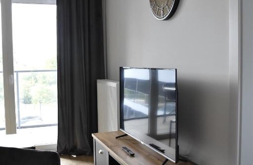 Witomino Apartment | Modern Silver Apartment Tower: Family-Friendly Retreat