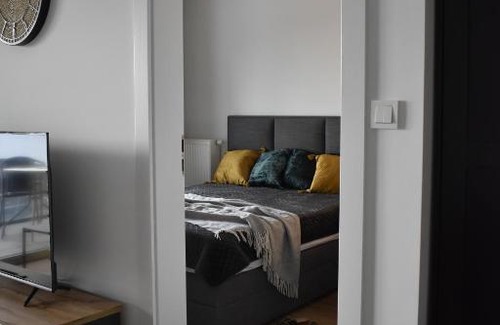 Witomino Apartment | Modern Silver Apartment Tower: Family-Friendly Retreat