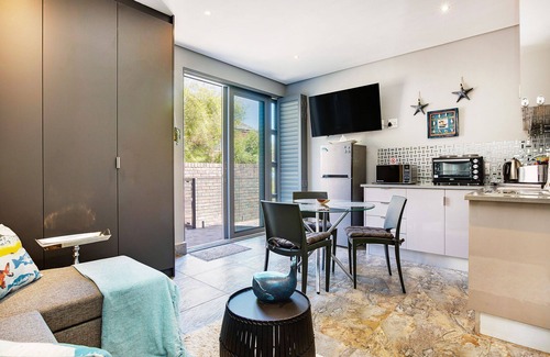 Camps Bay Apartment | Eco-Friendly Retreat with Oceanfront Views and Terrace