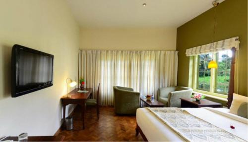 Thekkady Resort | Cozy Springdale Heritage: Oceanfront Escape with Pool