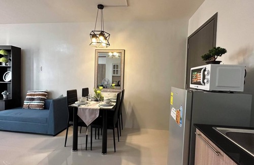 Puerto Princesa City Centre Condo | Studio 1queen Bed, sofa, kitchen and Balcony Puerto Princesa, Palawan