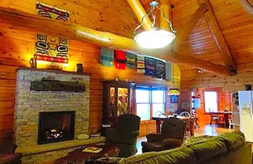 Eldorado House | Stunning Log Cabin Rental with a Fireplace near the Volga River State Recreation Area, Iowa